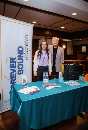 Forever Bound Adoption representatives at their information table during the 2025 United for Adoption Conference.